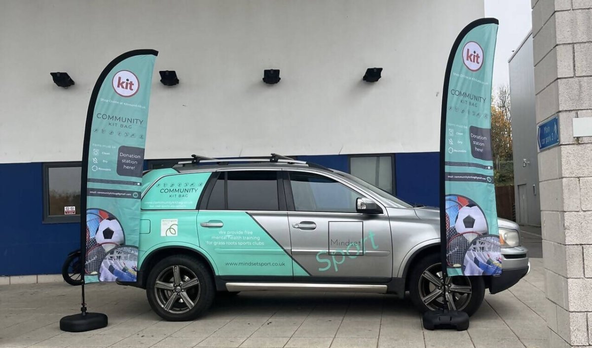 Community Kit Bag Car and Promotional banners at an event