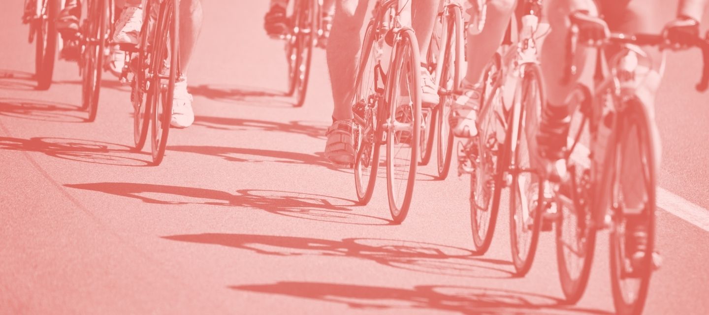 Cyclists on the road using gear from kitround’s cycling collection.