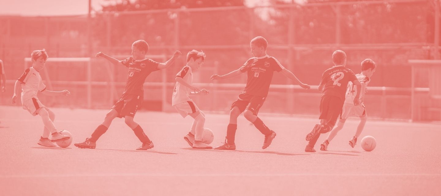 Children playing football in reused kit from kitround’s kids collection.