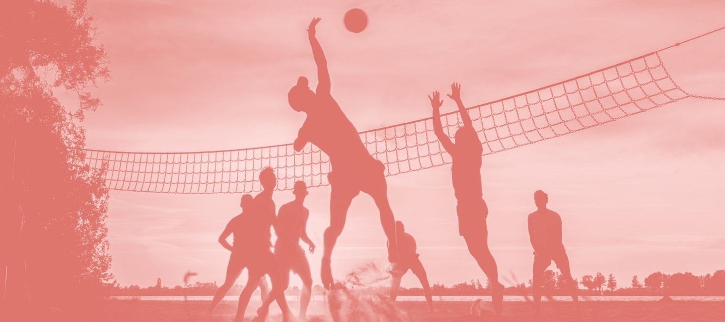 Team blocking a ball in game wearing kit from kitround’s volleyball range.