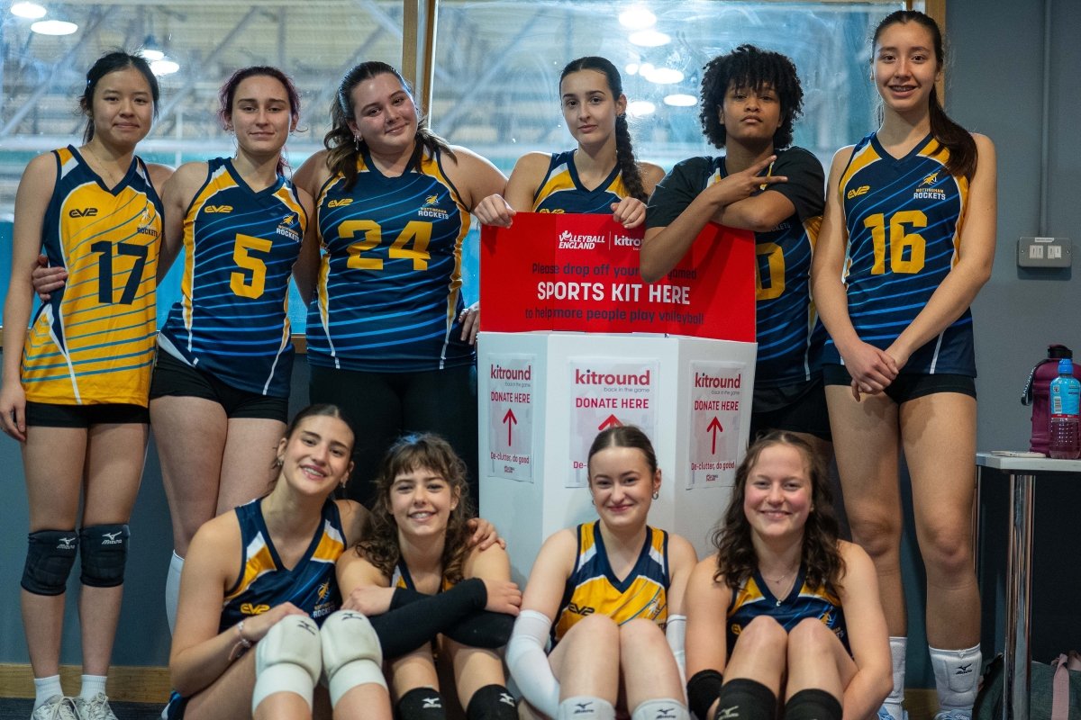 Volleyball Teams sitting around a kitbin as part of a kitdrop collection drive