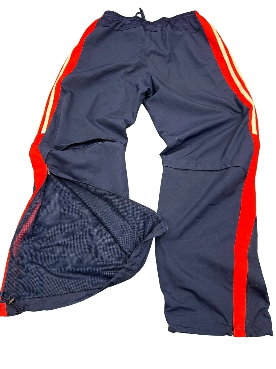 Enhanced Back view of navy Adidas tracksuit bottoms with red and white stripes and open ventilation zippers at the bottom