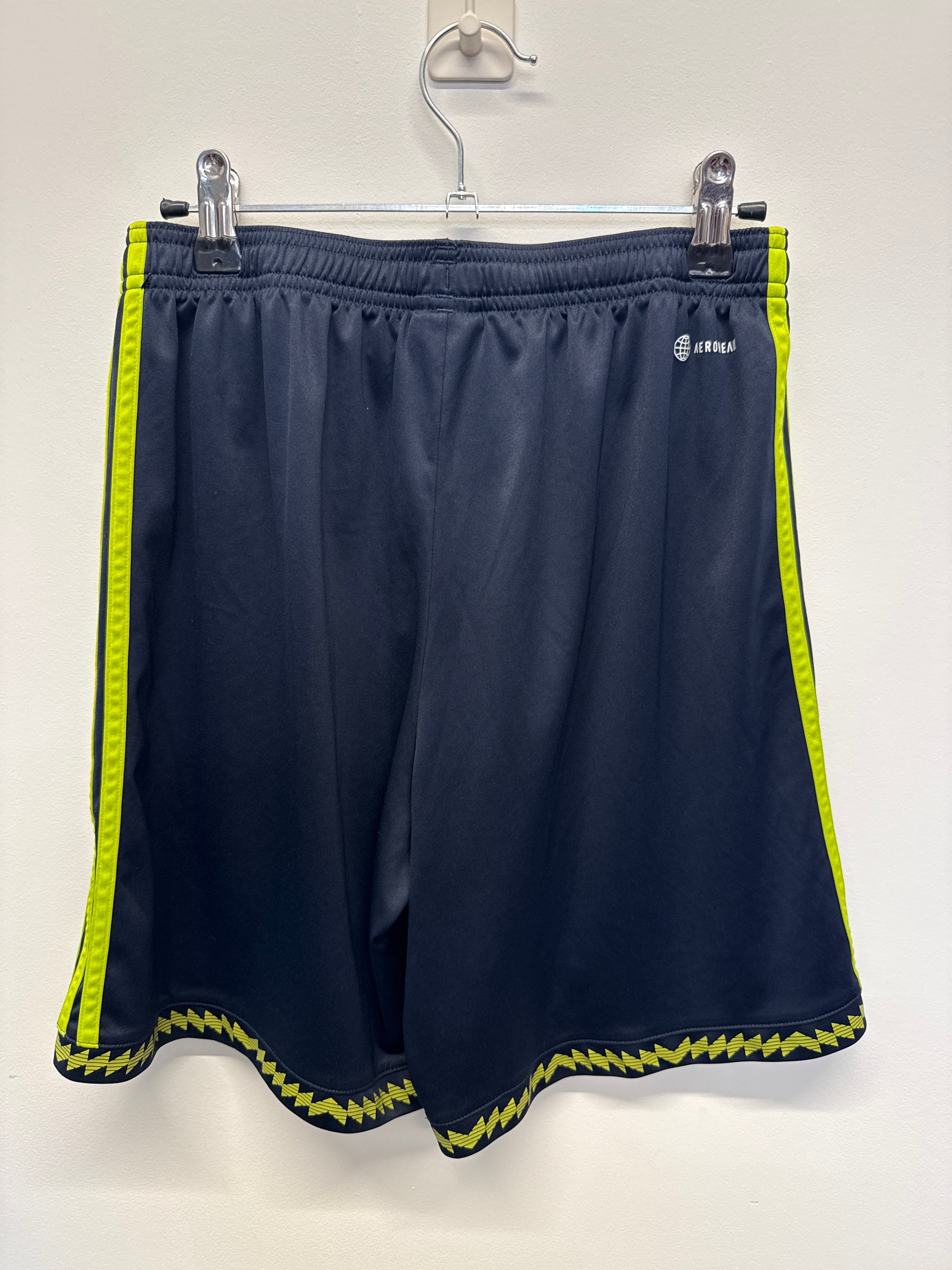 Back view of Manchester United adidas youth football shorts showing yellow side stripes and zig-zag trim