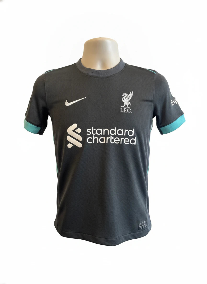 A Liverpool Kids Football Kit Chiesa 14 Nike Dri-FIT in black and teal, displayed on a mannequin against a clean white background.