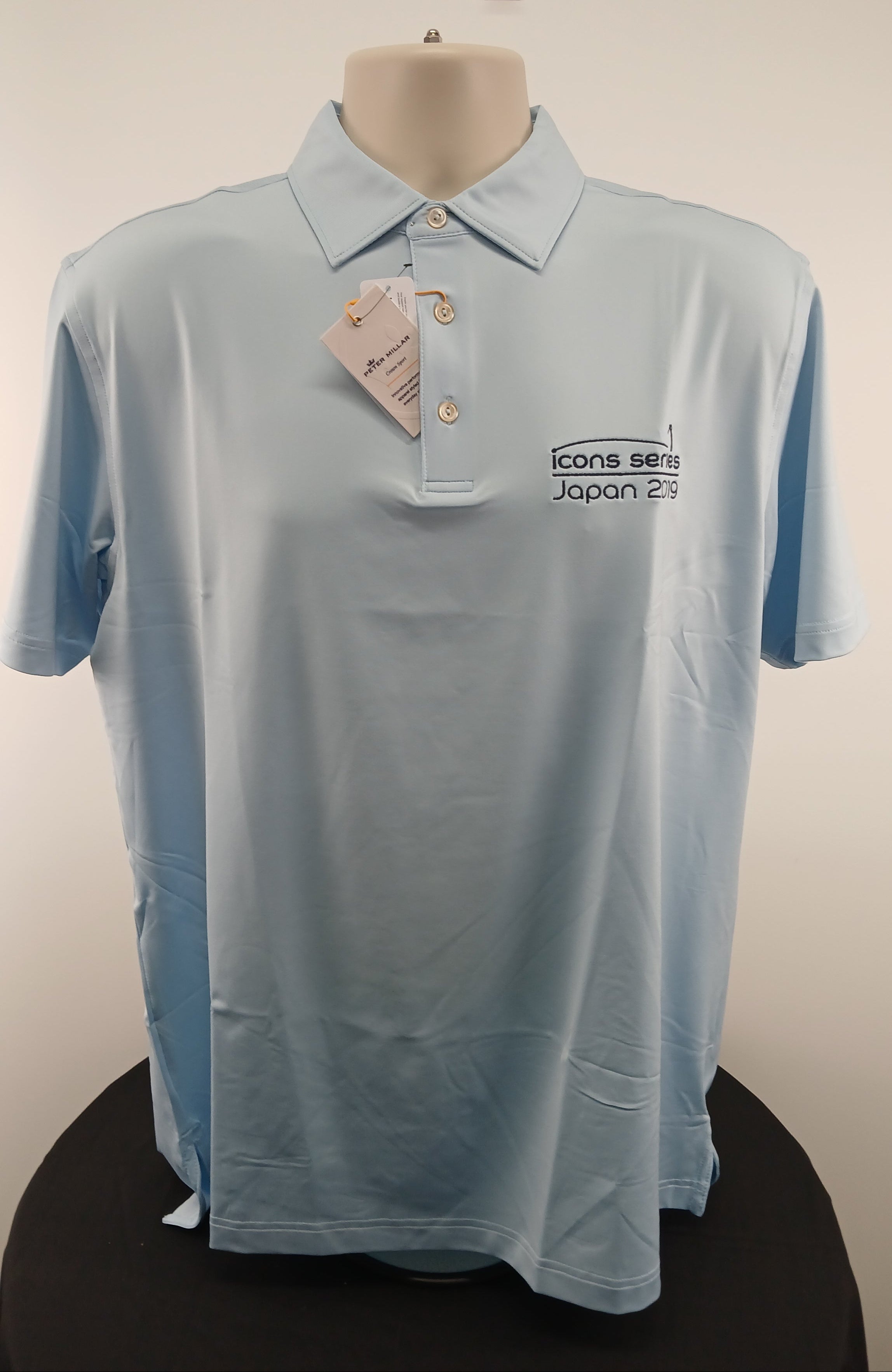 Front view of Peter Millar Icons Series Japan 2019 limited edition polo shirt in oasis blue, size M, showing embroidery and tags