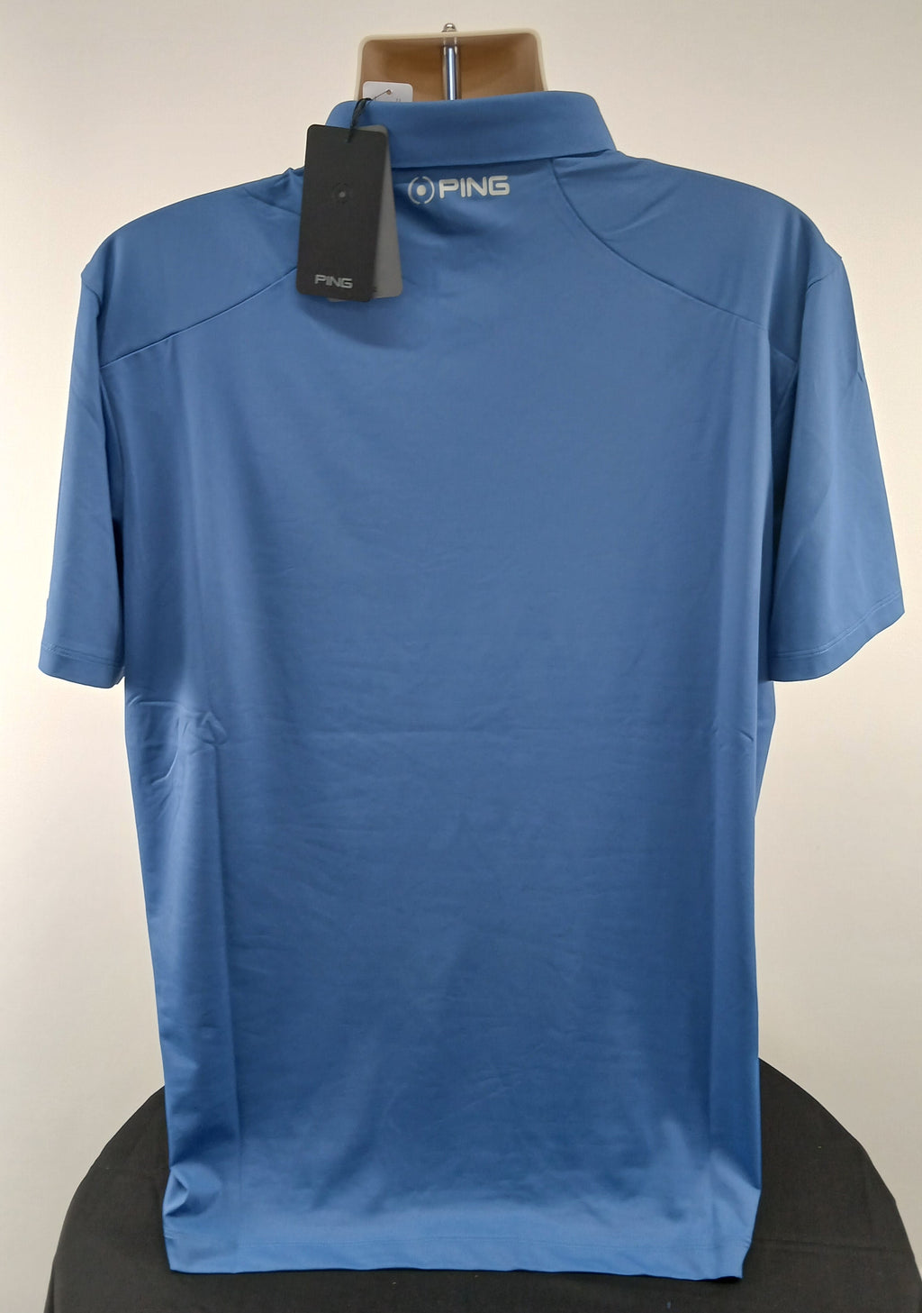Back view of Ping Solheim Cup 2023 men's horizon blue golf polo shirt, size XL with Ping branding on collar