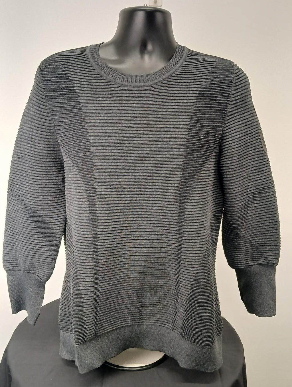 Front view of dark grey Under Armour men's knitted jumper on mannequin