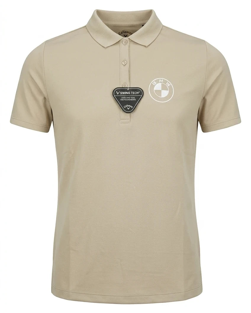 A professional studio photograph of the Men's Callaway Swingtech short-sleeved polo shirt in beige with a clean white background, showcasing the BMW logo and a Swing Tech garment tag.