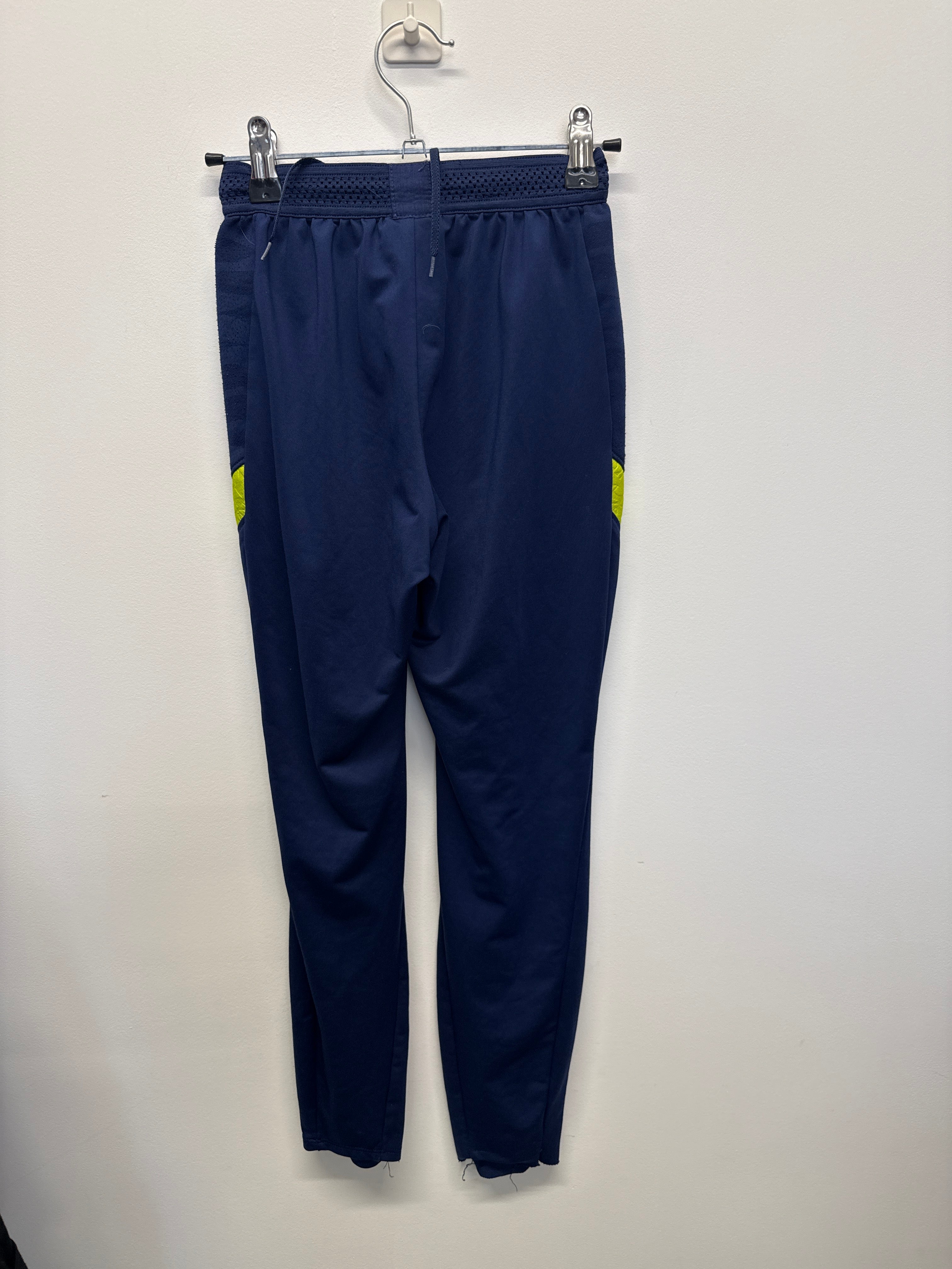 Back view of navy blue Nike Tottenham Hotspur Dri-FIT training pants with yellow accents