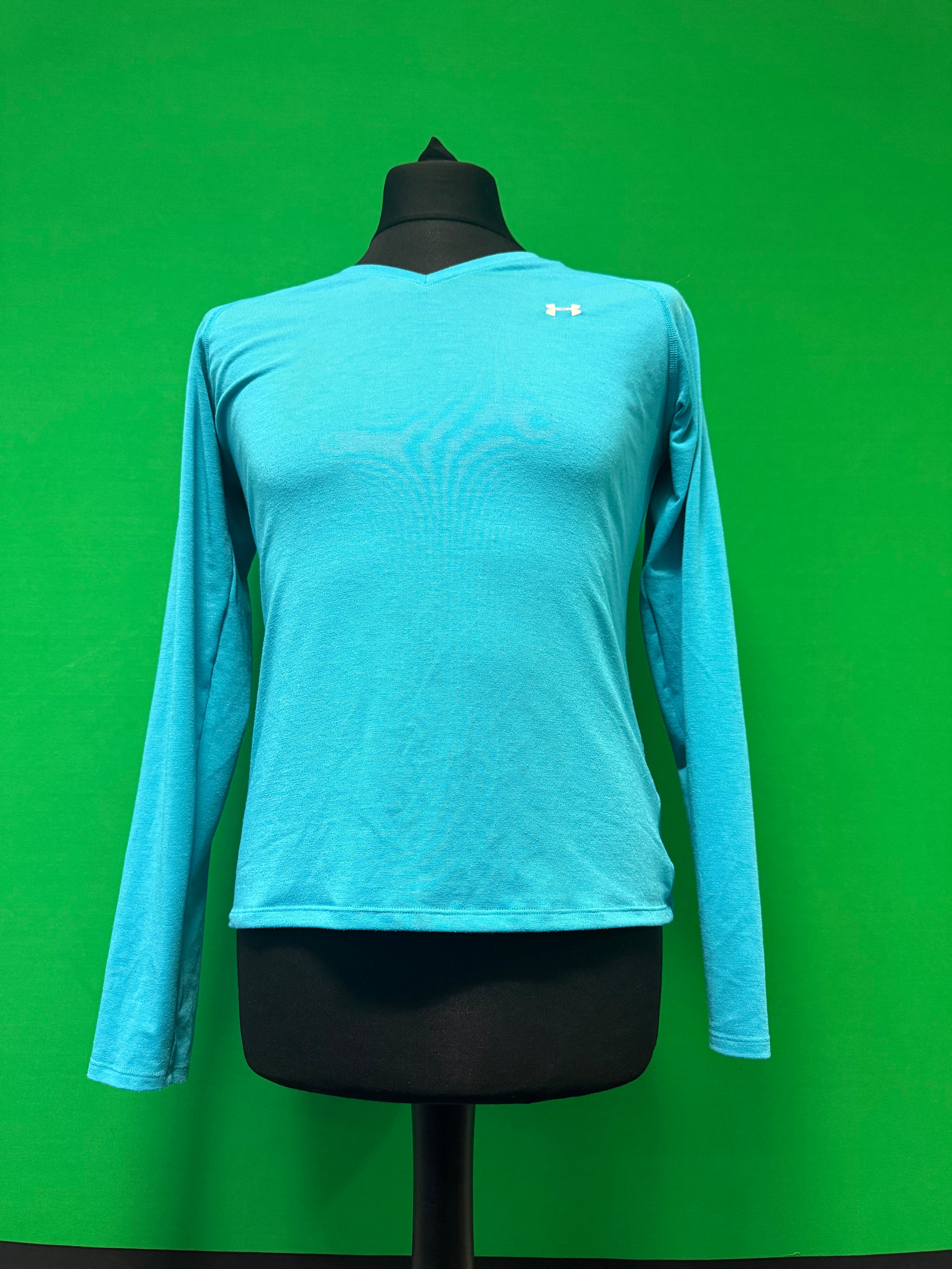 Under Armour long sleeve blue performance t-shirt on black mannequin against green background