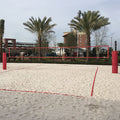 Outdoor sand volleyball court with red boundary marker lines
