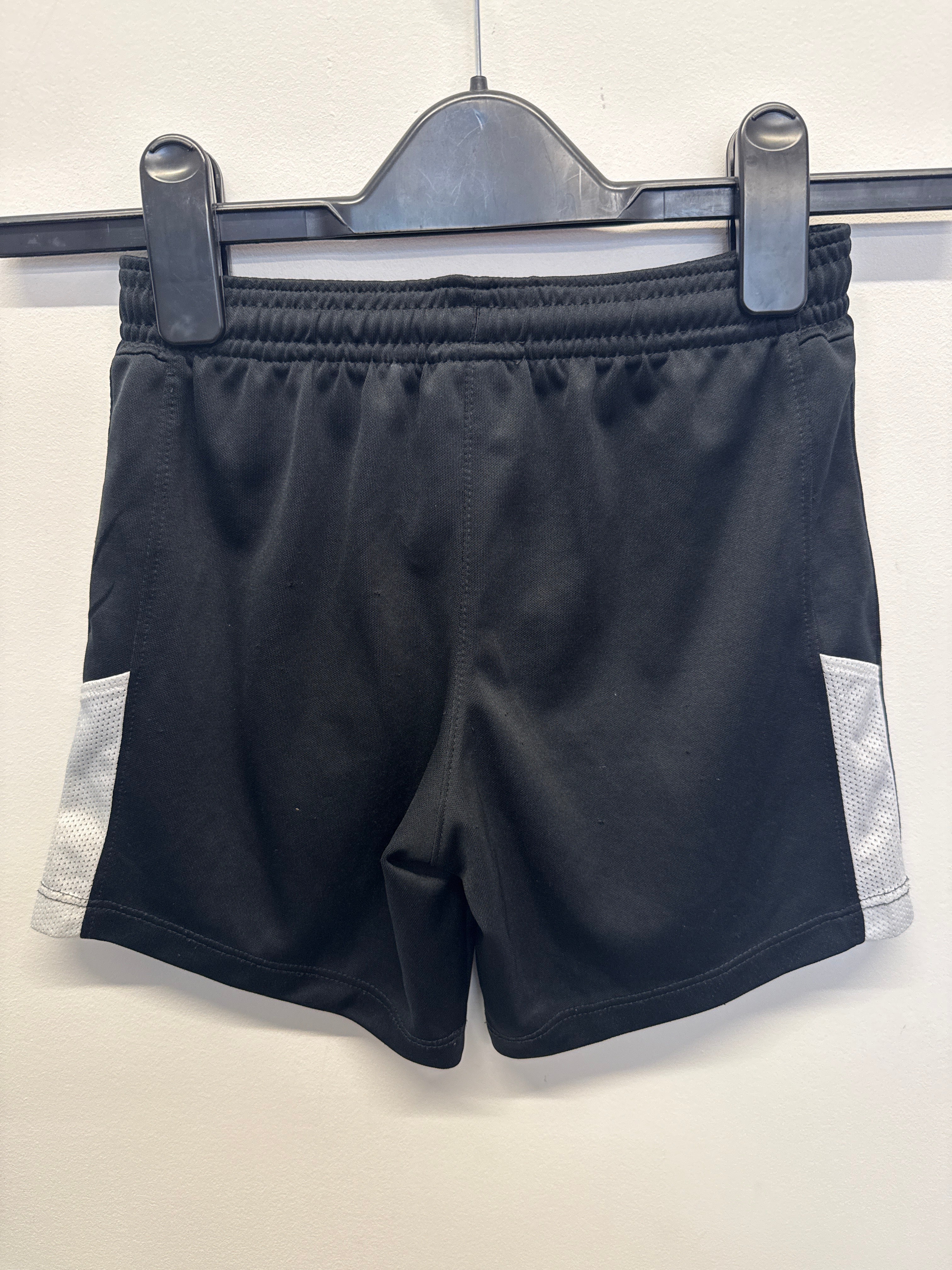 Back view of black Nike football shorts with white mesh side panels