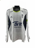 An adidas England Cricket Long Sleeve Jersey in white with black and lime green accents, featuring the Brit Insurance logo and the England cricket crest.
