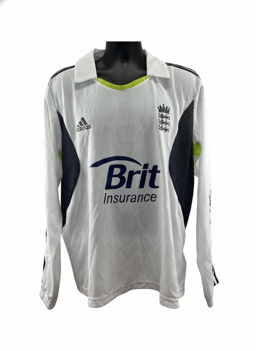 An adidas England Cricket Long Sleeve Jersey in white with black and lime green accents, featuring the Brit Insurance logo and the England cricket crest.
