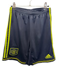 Front view of Manchester United adidas youth football shorts with club badge and yellow accents