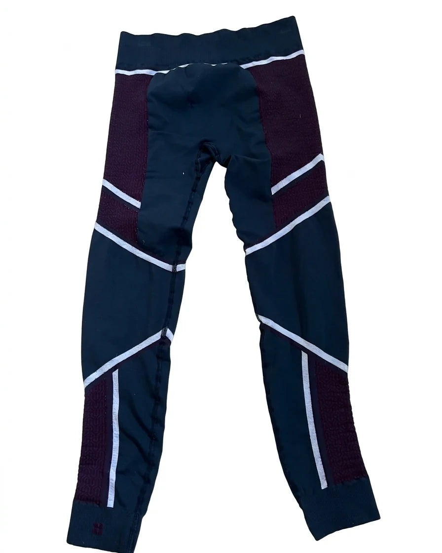 Enhanced Back view of Sweaty Betty multi-coloured patterned leggings showing the ribbed waistband and ankle cuffs