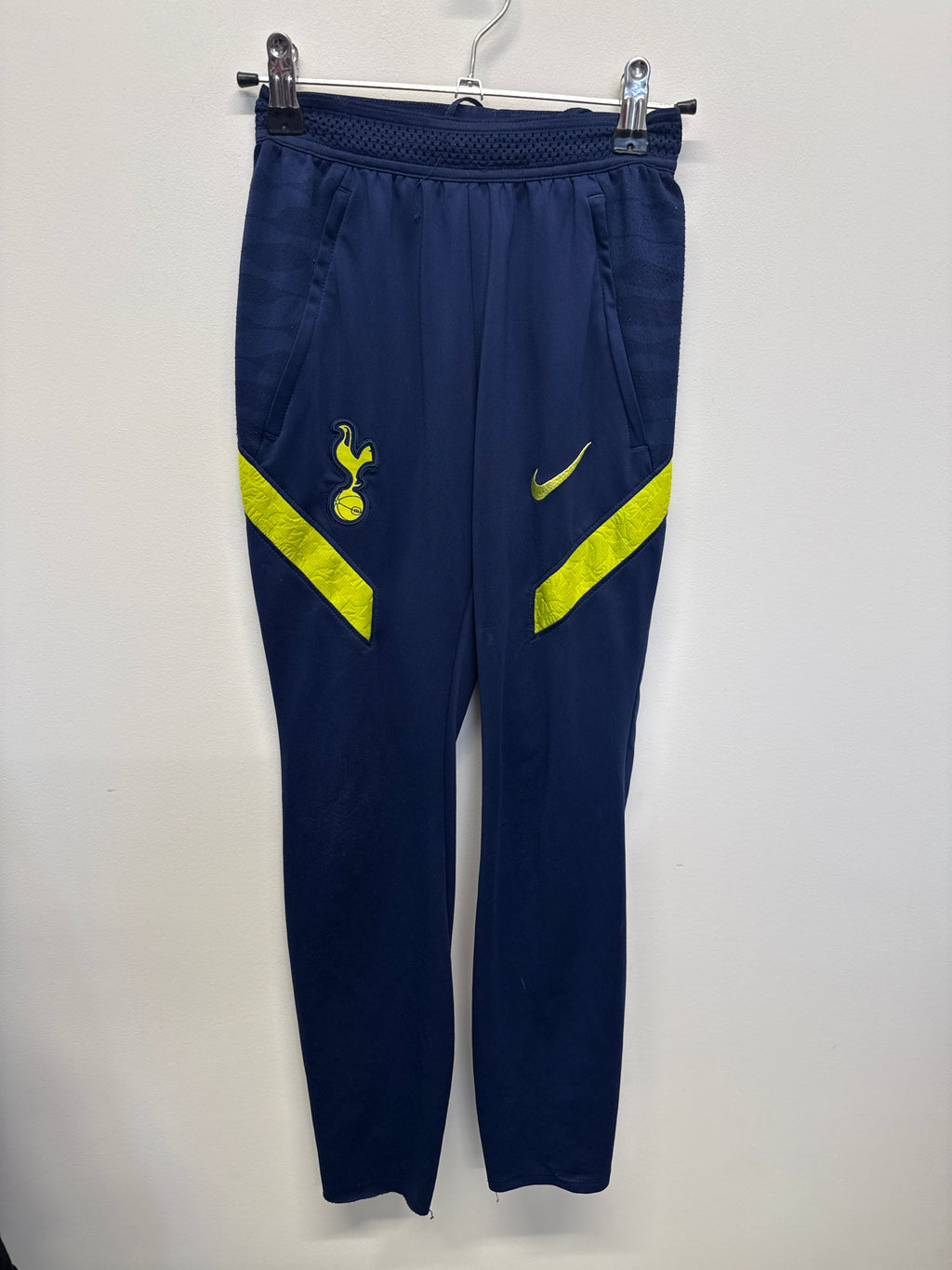 Front view of navy blue Nike Tottenham Hotspur Dri-FIT training pants with yellow accents