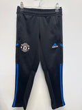 Front view of Manchester United adidas kids' black training pants with blue stripes and embroidered logos