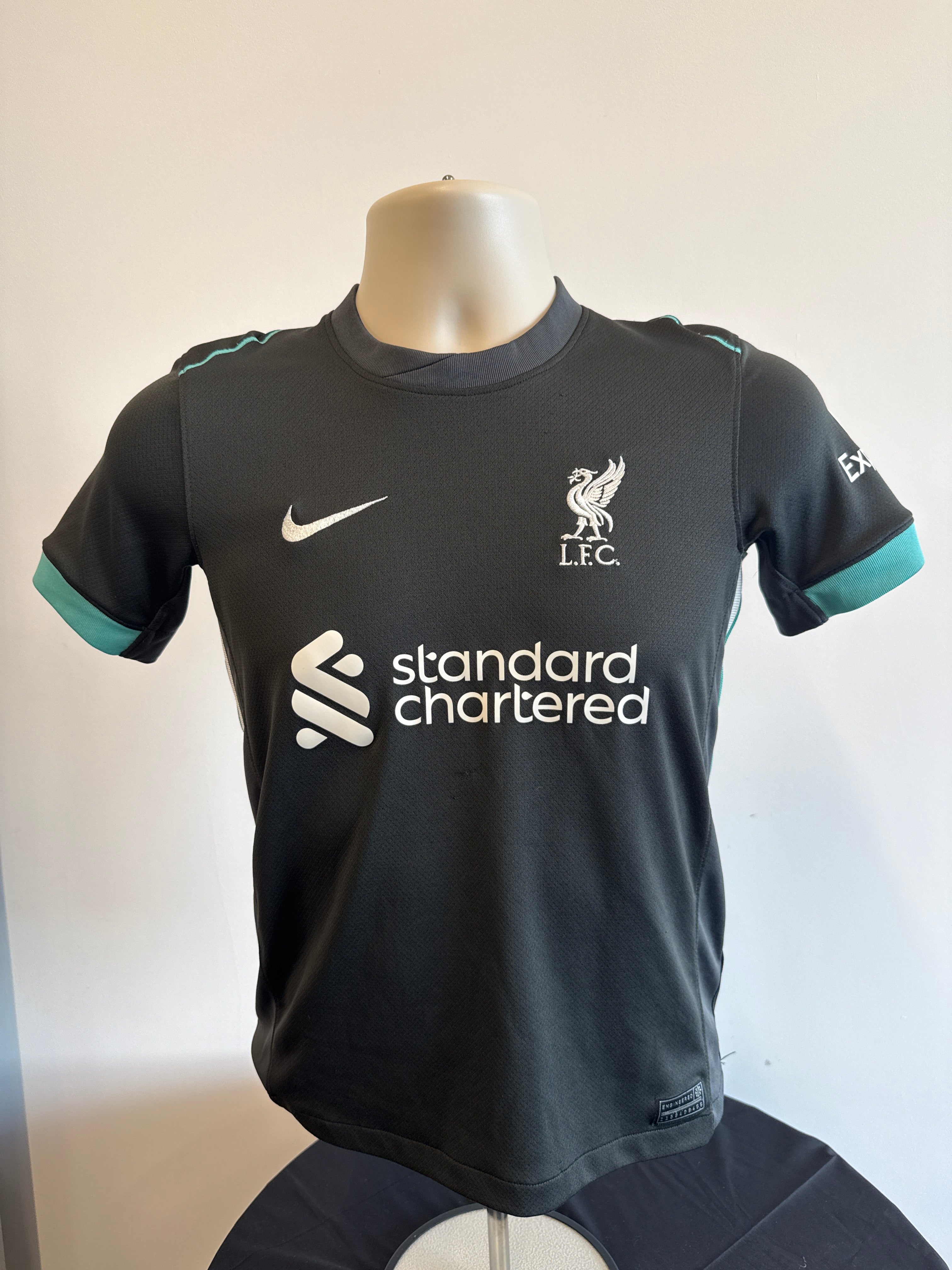 Front view of Liverpool kids football shirt by Nike with LFC crest and sponsor