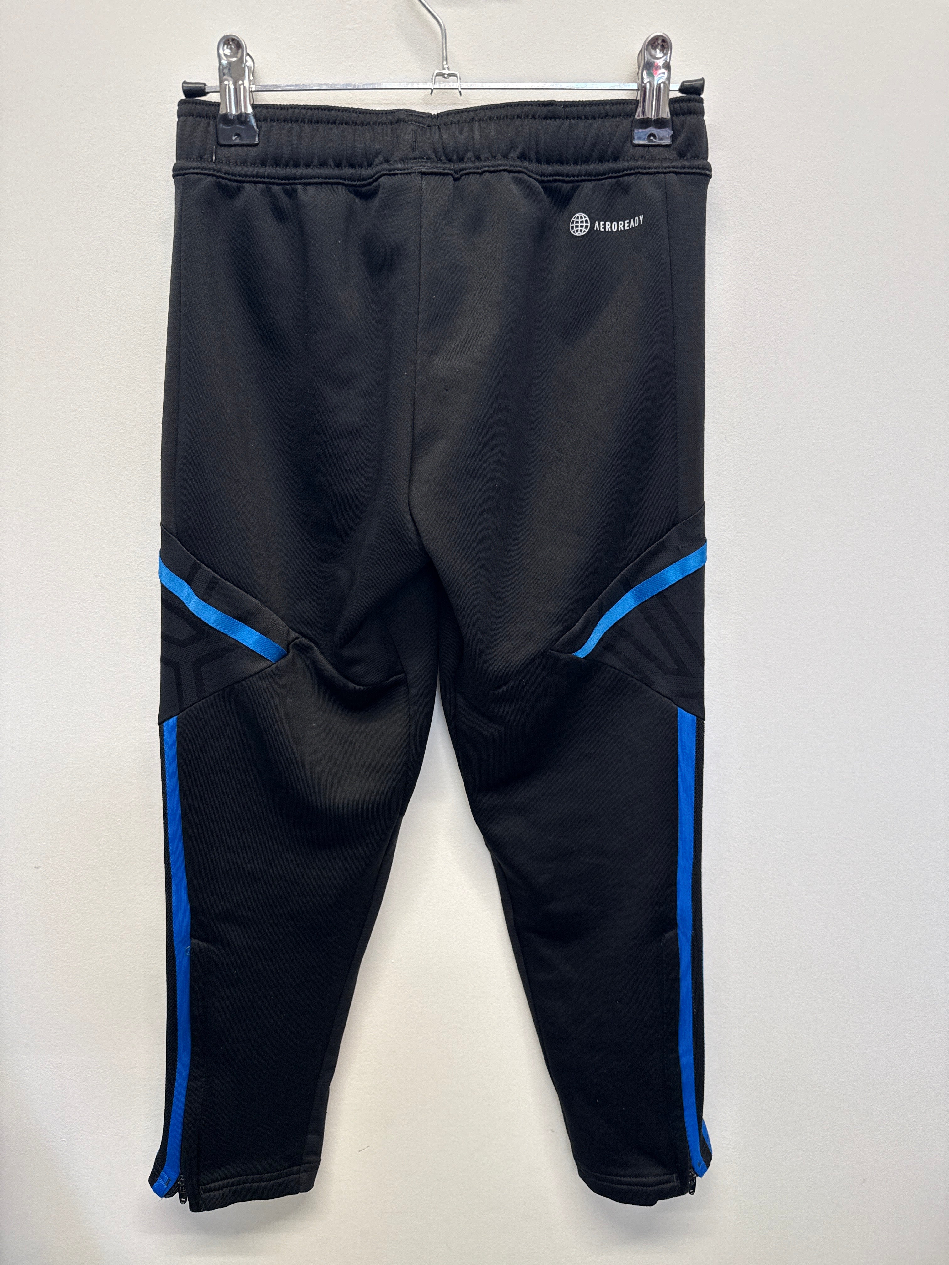 Back view of Manchester United adidas kids' black training pants with blue stripe details