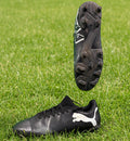 Side view and studded sole of black Puma football boot with white logo