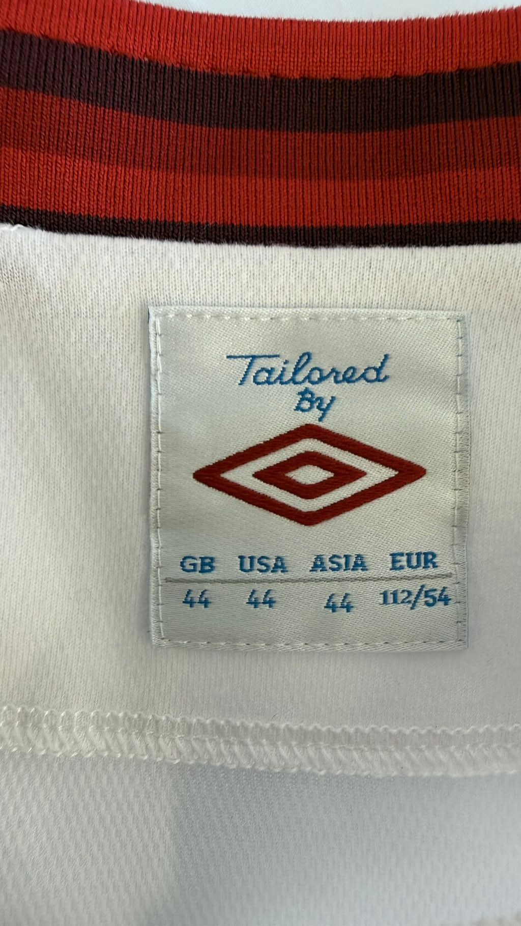 Umbro size and care label with red trimmed collar, size 44 XL