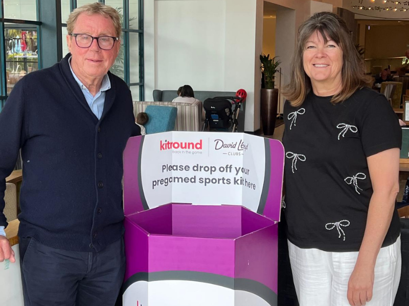 Harry Rednapp and Wendy Carter pose in front of a David Lloyd Club branded kitbin 