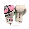 Pair of white and pink RDX boxing gloves displayed on a stand against a green background
