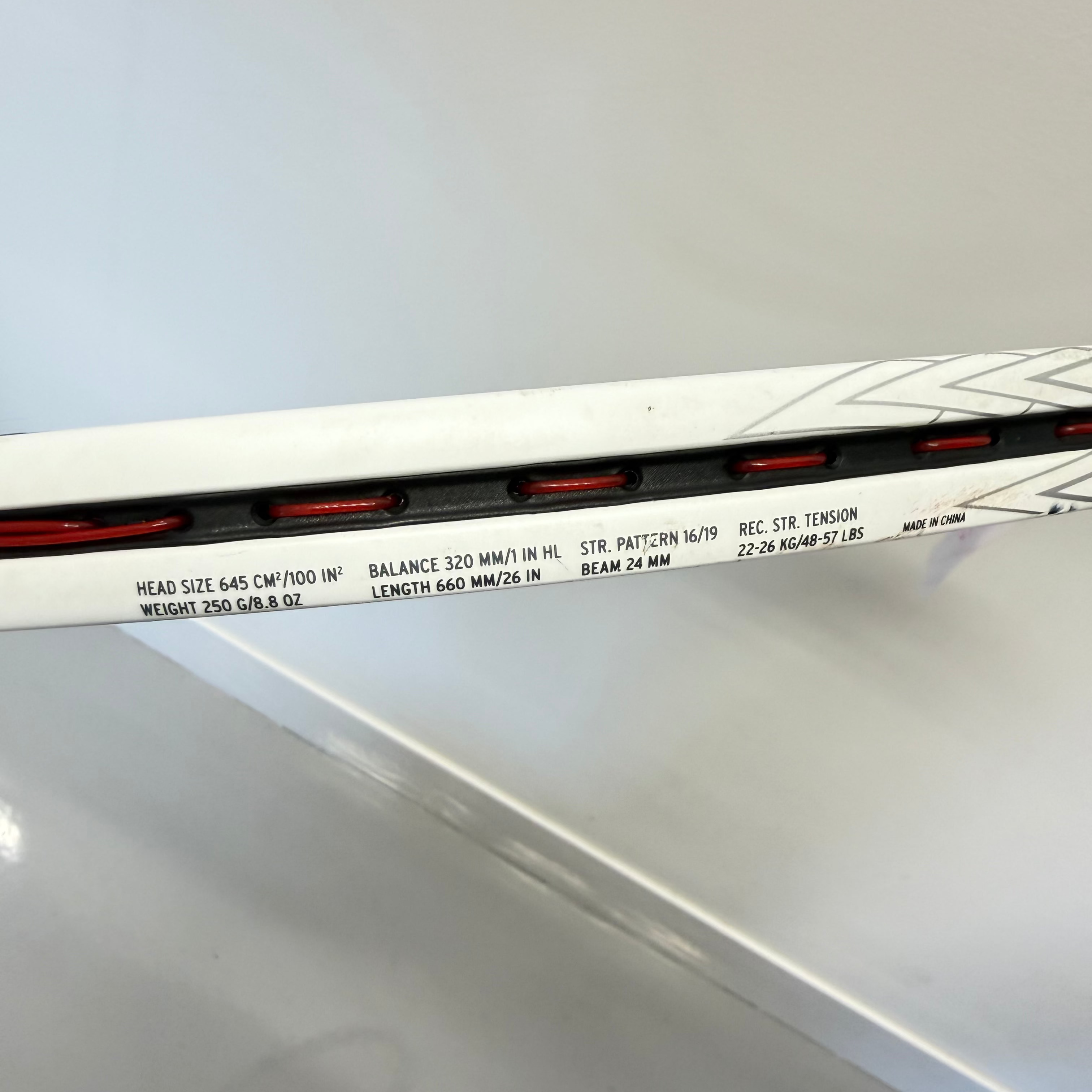 Close-up of Head Speed Junior Tennis Racket frame with specifications