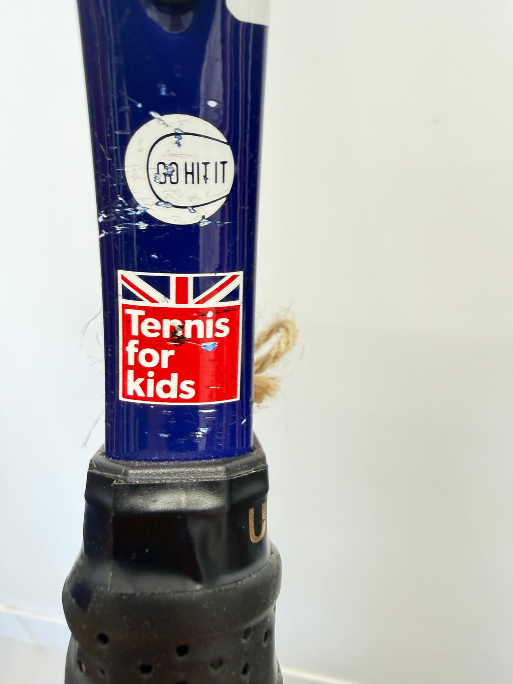 Close-up of Babolat kids tennis racket grip showing Tennis for Kids badge