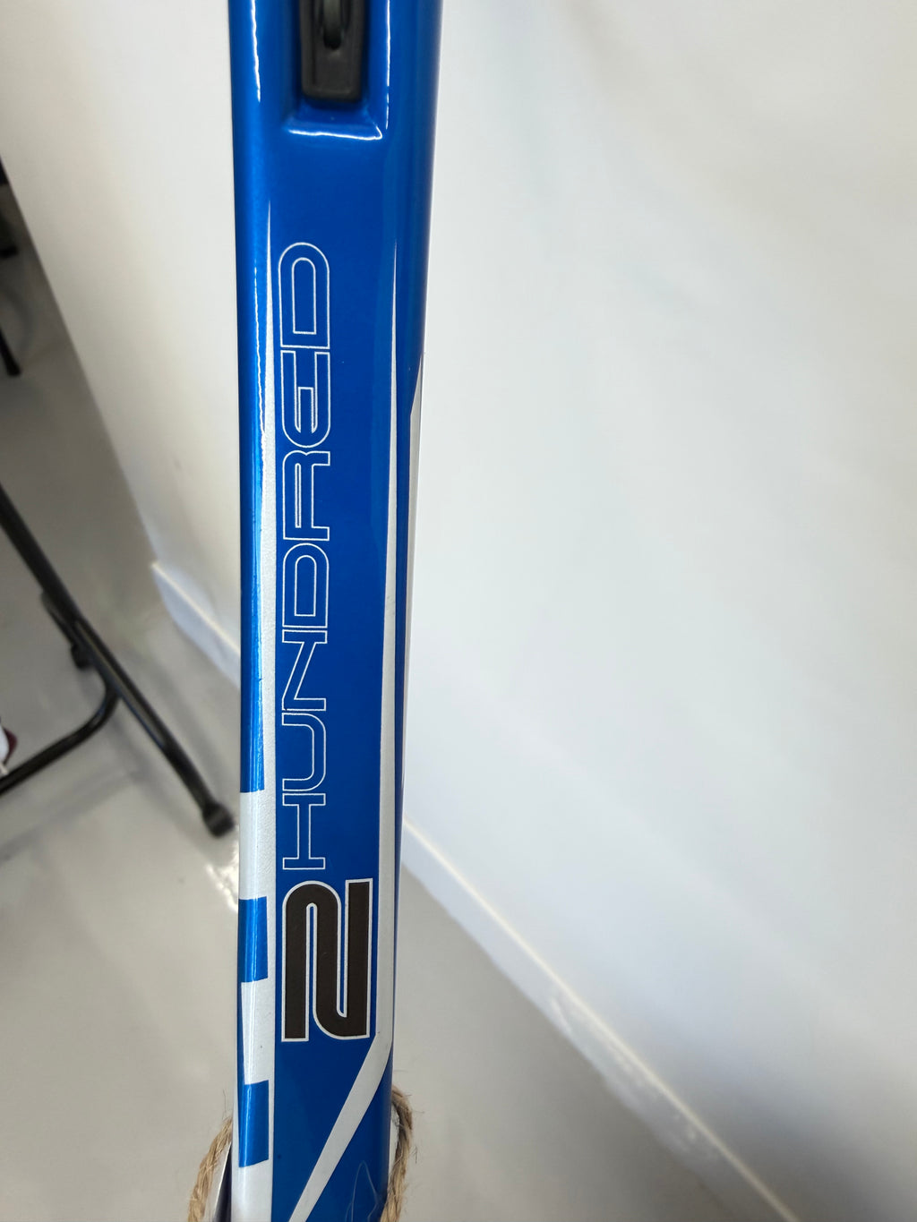 Close-up of 2 Hundred branding on racket frame