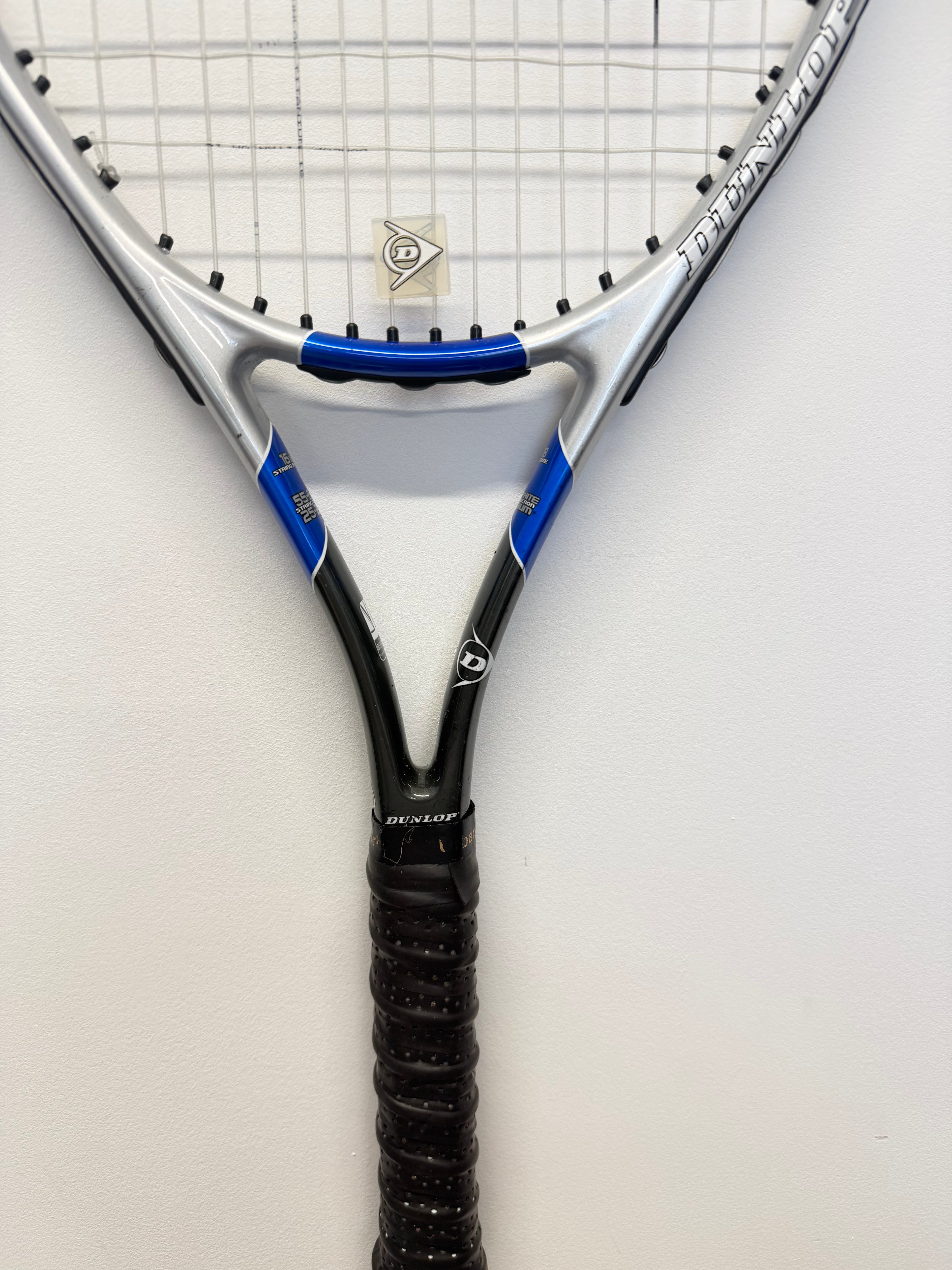 Mid-section of Dunlop racket showing grip and branding