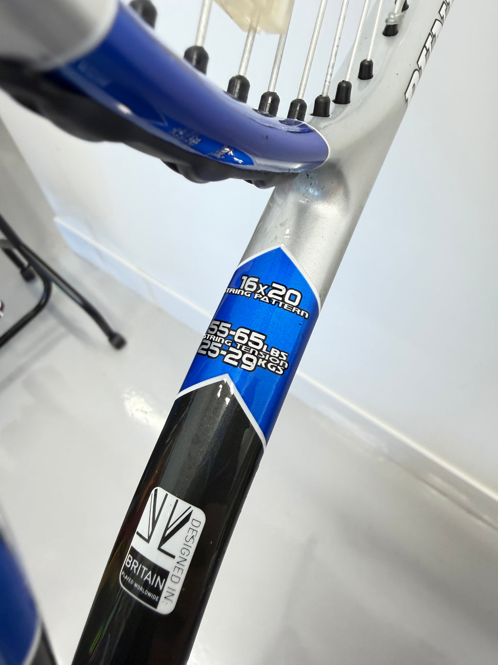 Close-up of Dunlop tennis racket frame with string pattern details