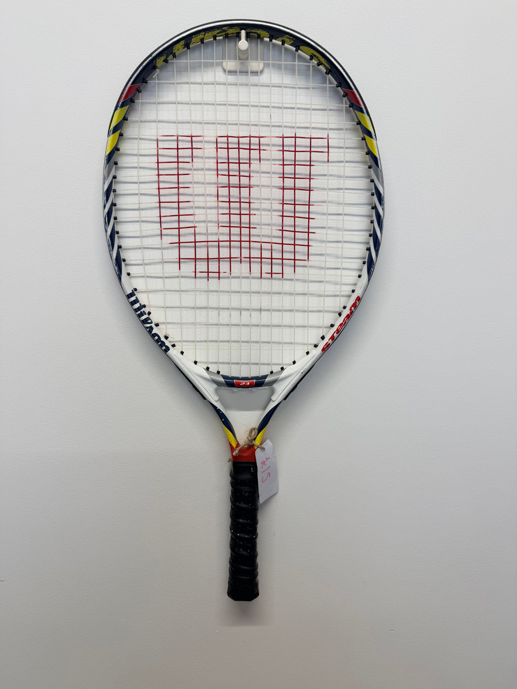 Front view of Wilson Steam tennis racket with red Wilson logo on the strings, multi-colour frame, and black grip