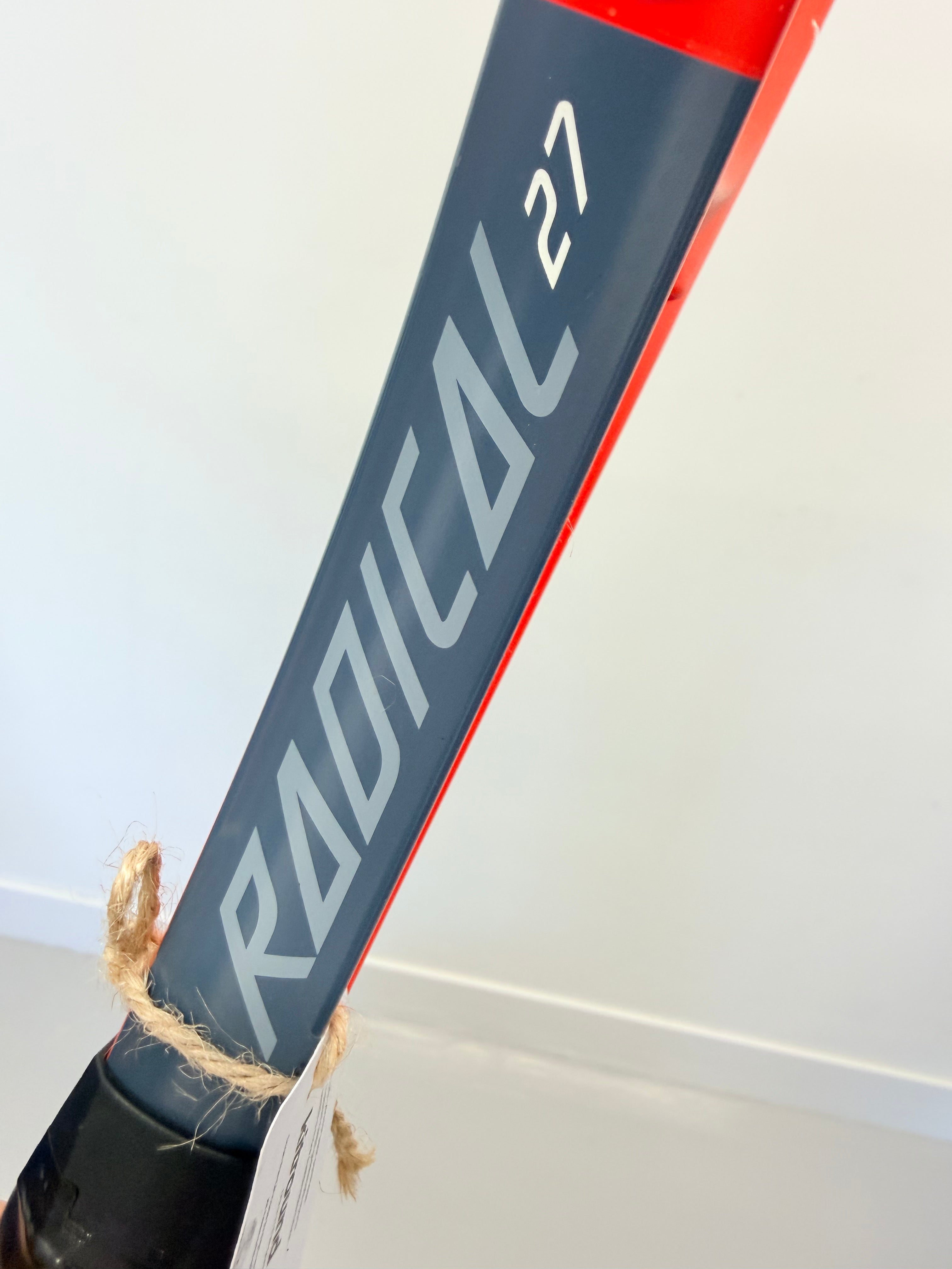 Detailed view of Head Radical 27 branding on black and red tennis racket shaft