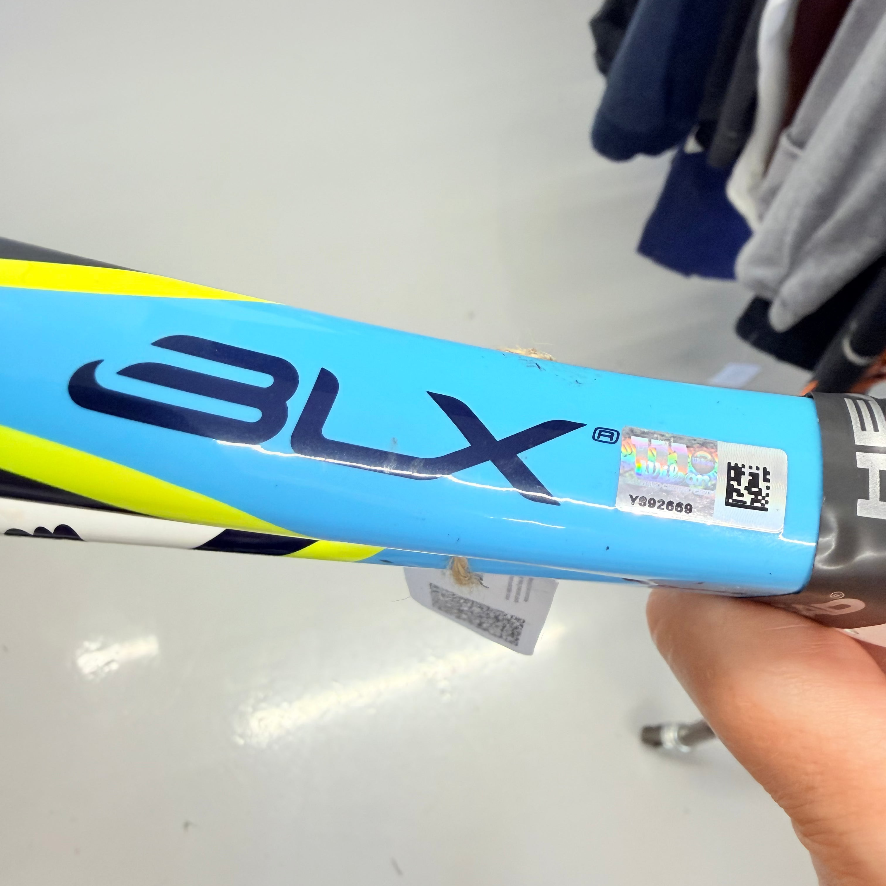 Close-up of Wilson BLX tennis racket shaft showing blue colour and logo