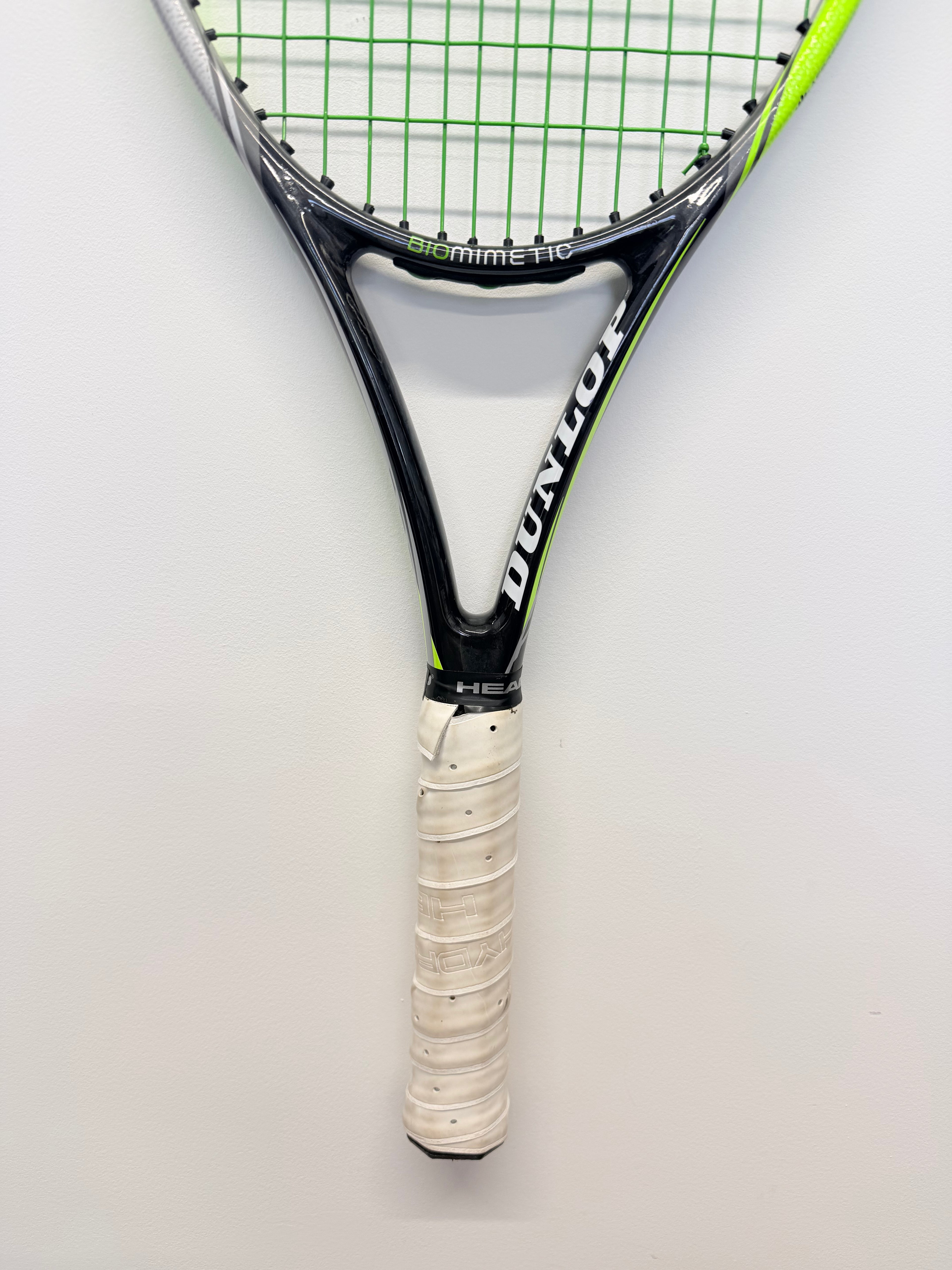 Handle and lower frame of Dunlop tennis racket with white grip