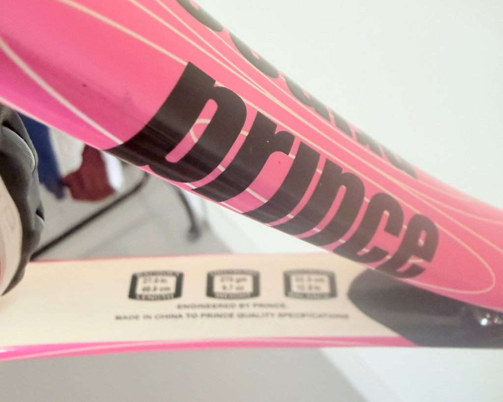 Close-up of Prince tennis racket branding and specifications label