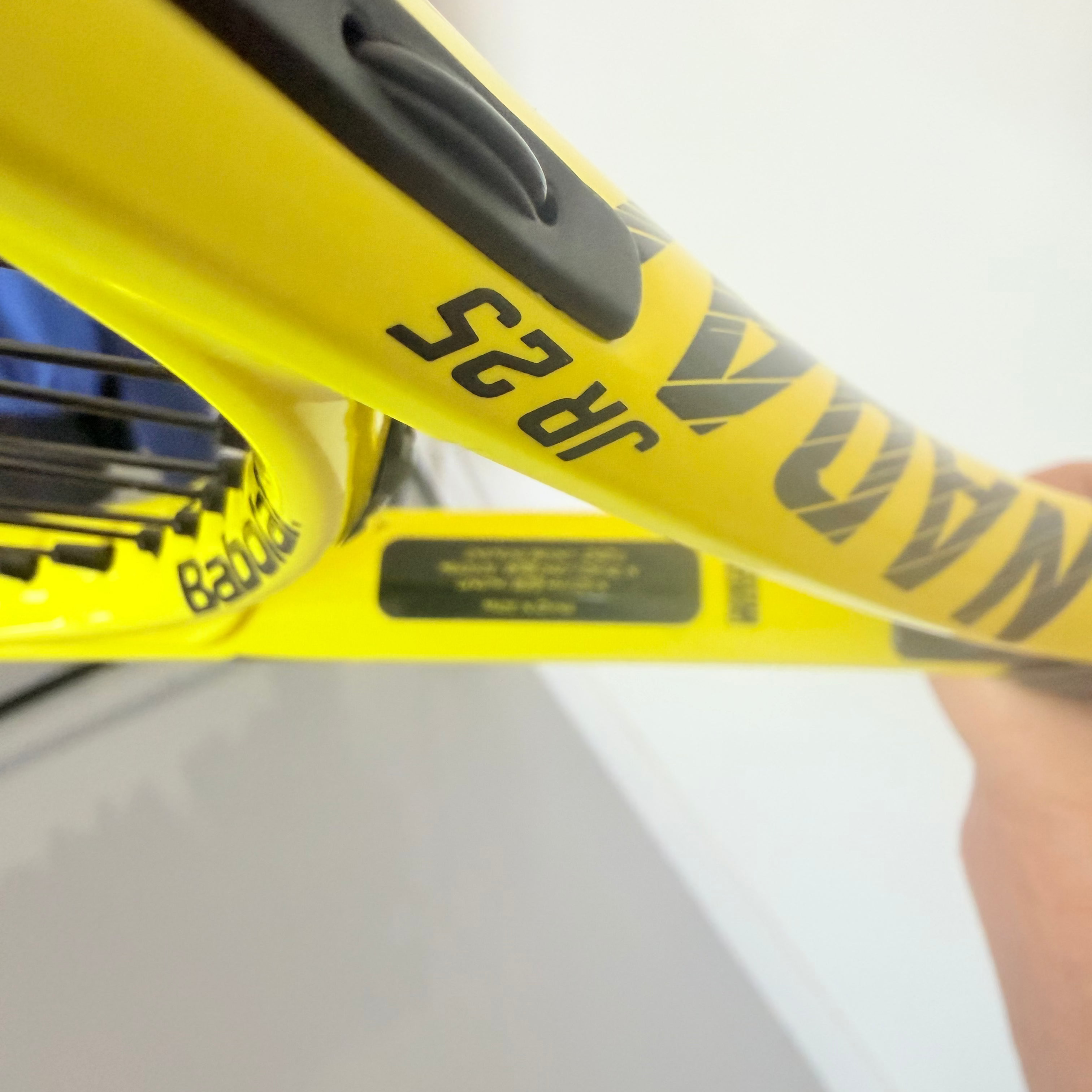 Detail of Babolat Nadal JR25 branding and specifications on racket