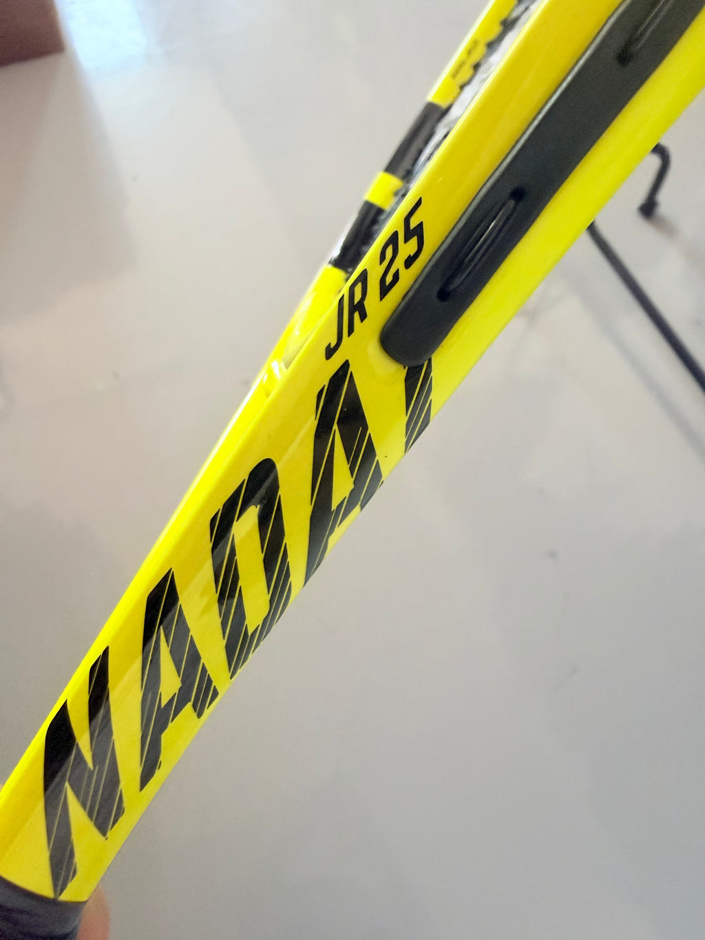 Close-up of Babolat Nadal JR25 tennis racket yellow frame