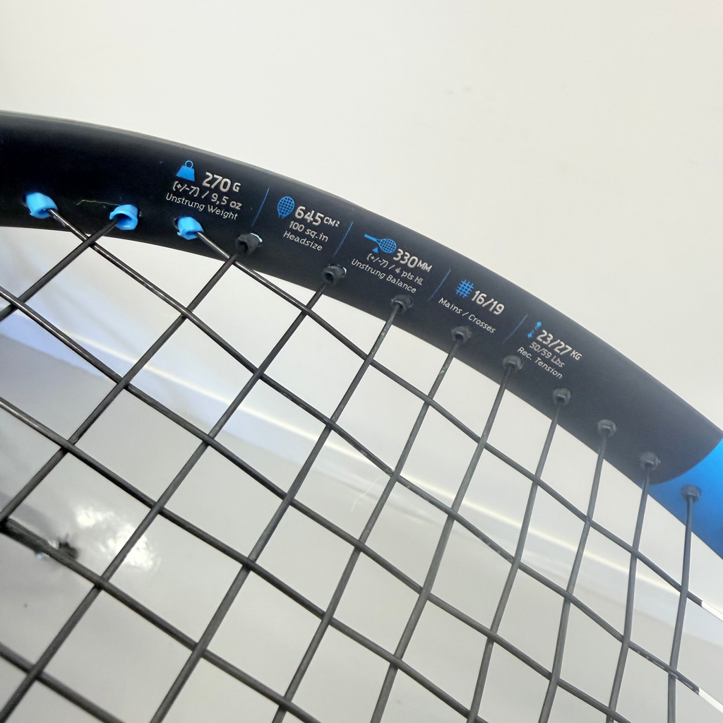 Close-up of Babolat Drive Lite tennis racket specifications on blue frame