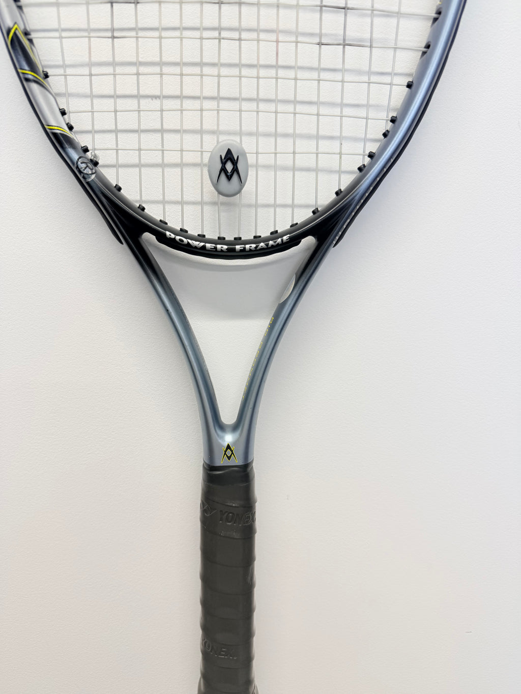 Partial view of Völkl tennis racket handle and power frame head