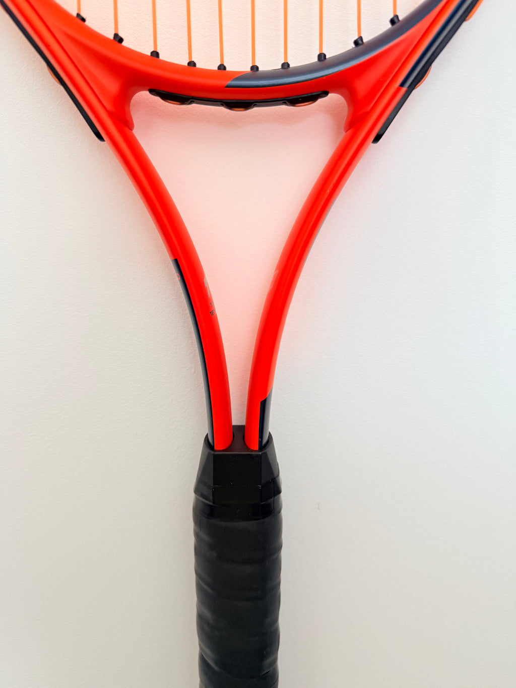 Close-up of Head Radical tennis racket black grip and throat