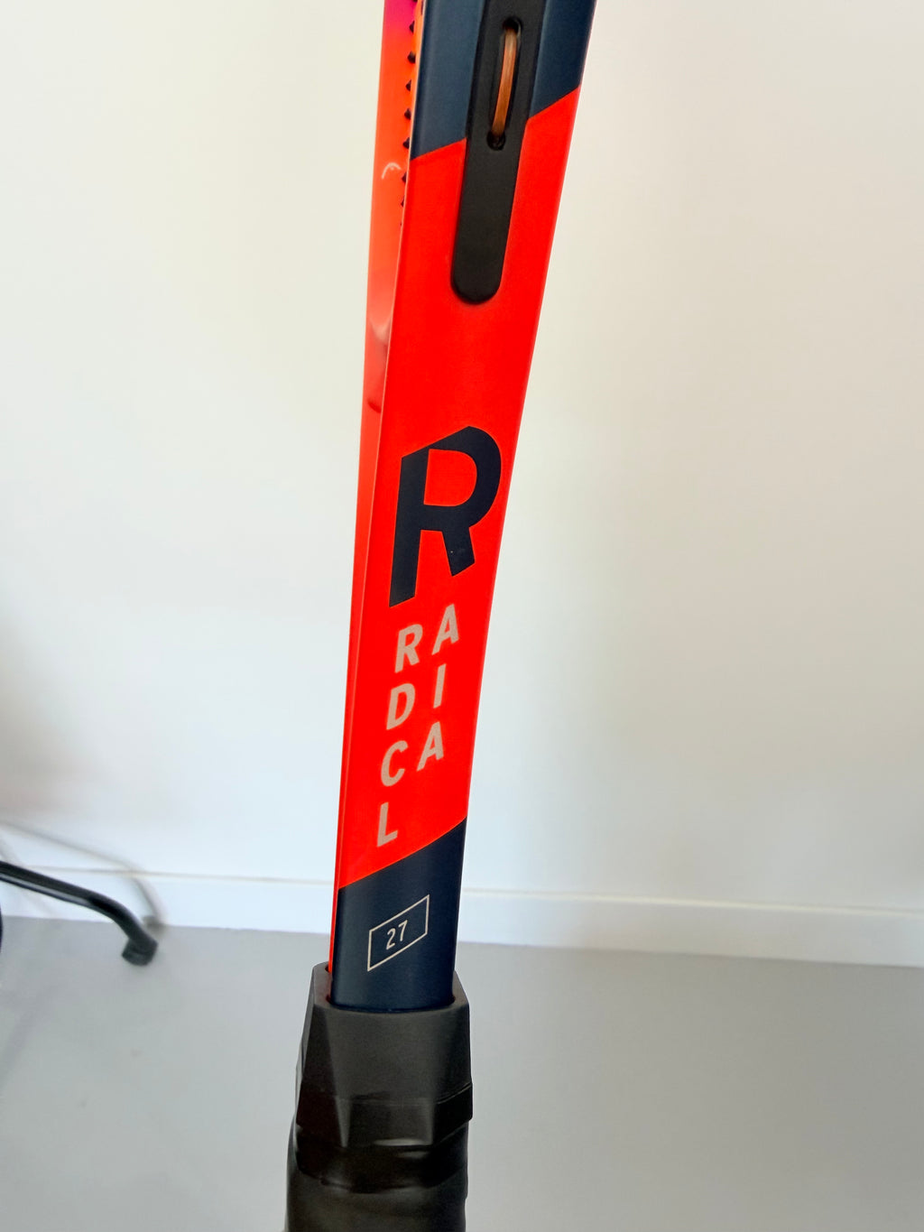 Side view showing 'Radical' branding and racket specifications