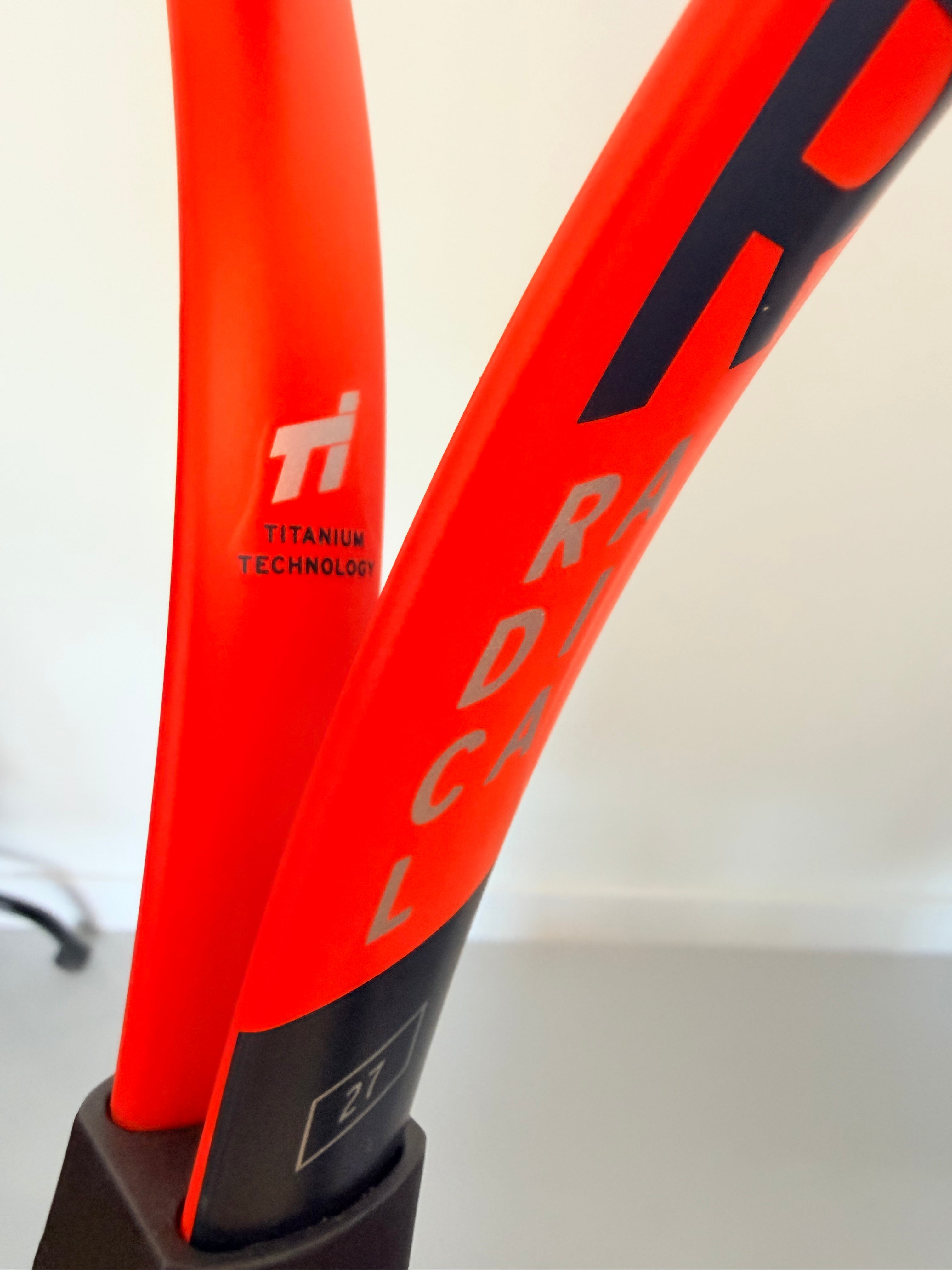 Detail showing 'Titanium Technology' marking on tennis racket