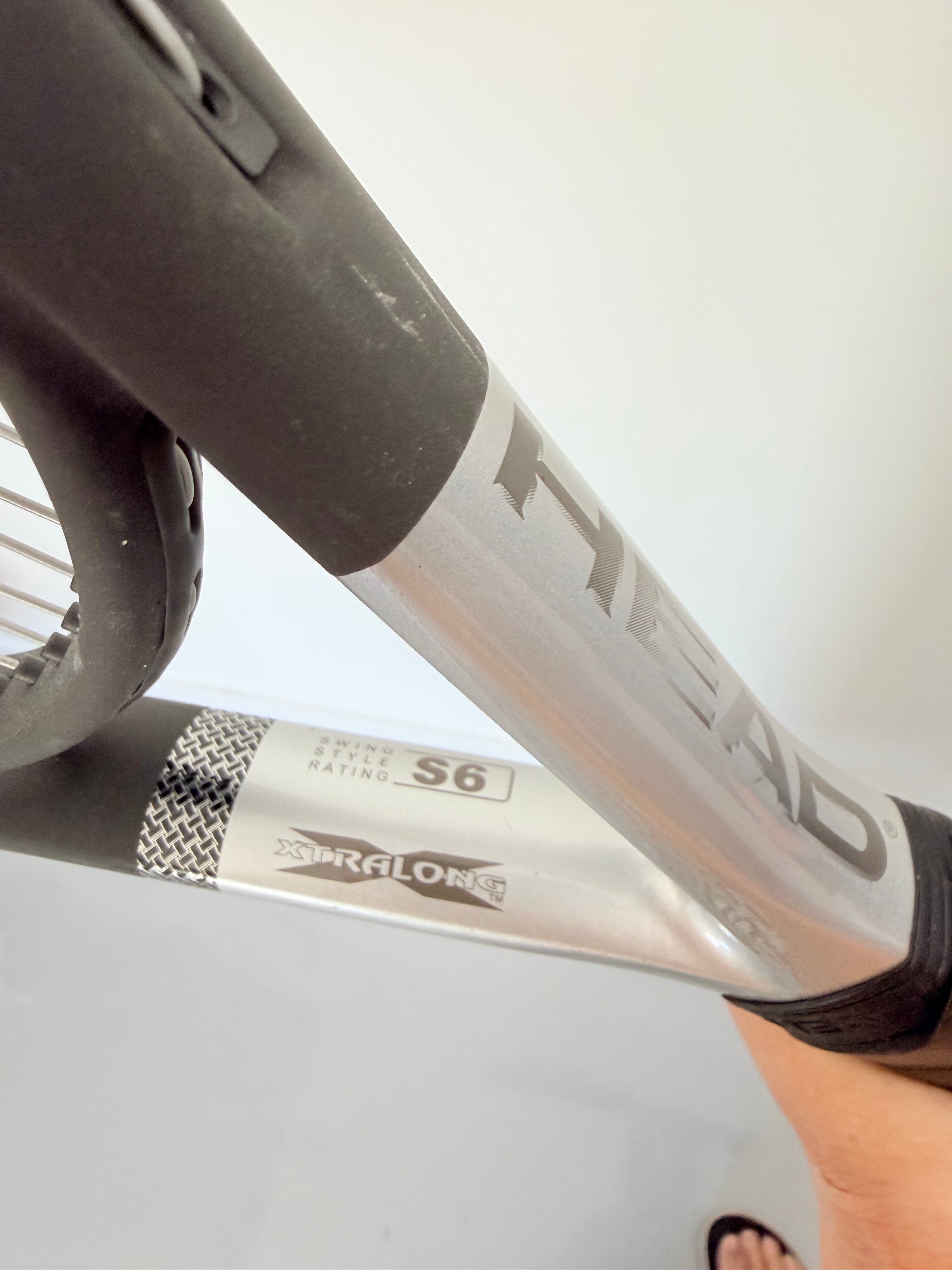Detail of HEAD Ti.S6 tennis racket shaft with branding and Xtralong label