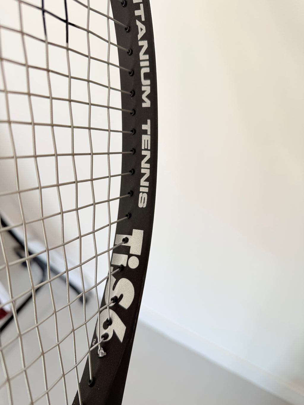 Close-up of Head Ti.S6 tennis racket frame showing titanium text