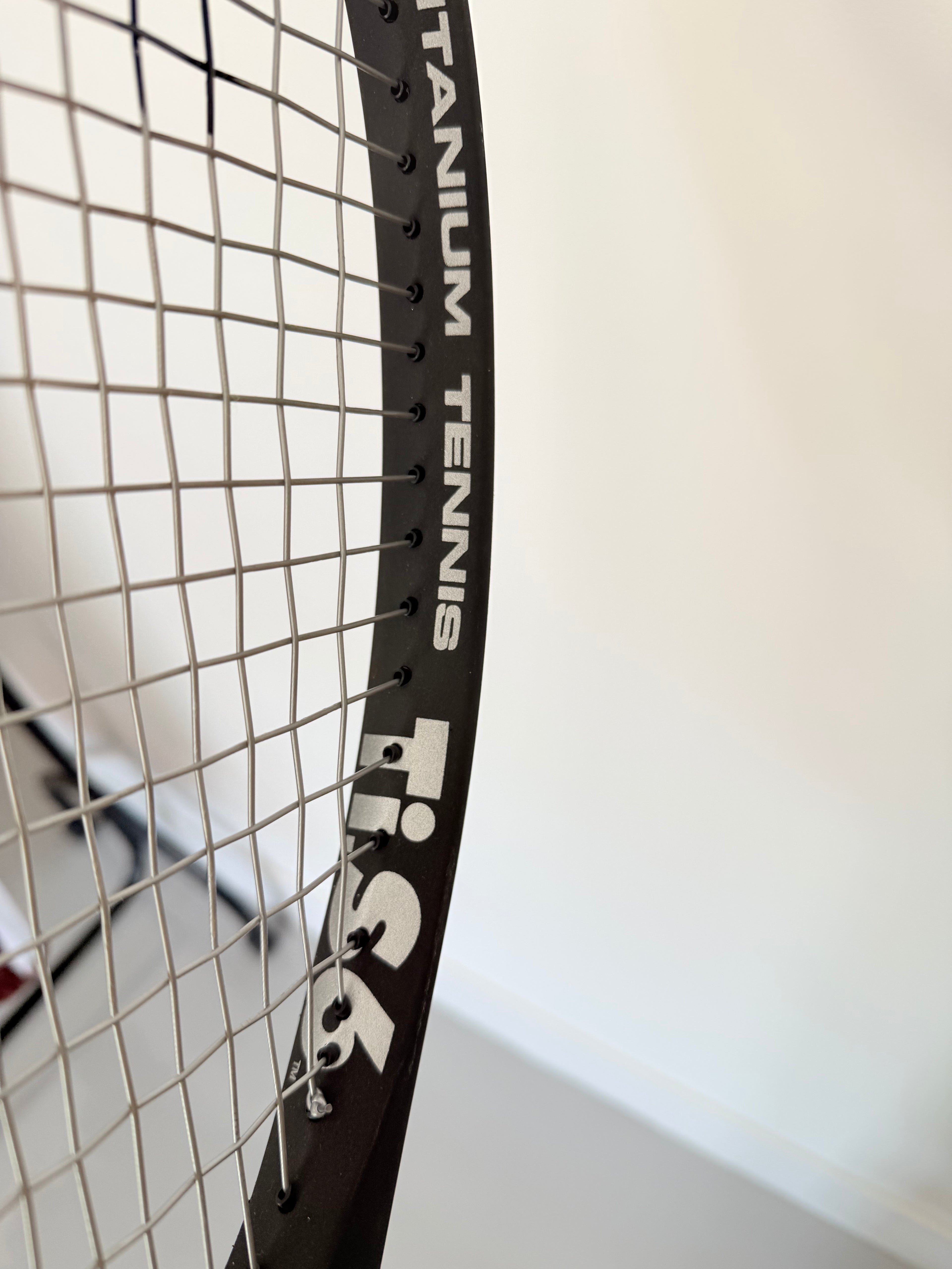 Close-up of Head Ti.S6 tennis racket frame showing titanium text