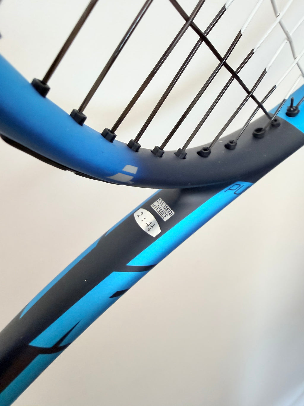 Detail of Babolat tennis racket frame showing 2.44 marking
