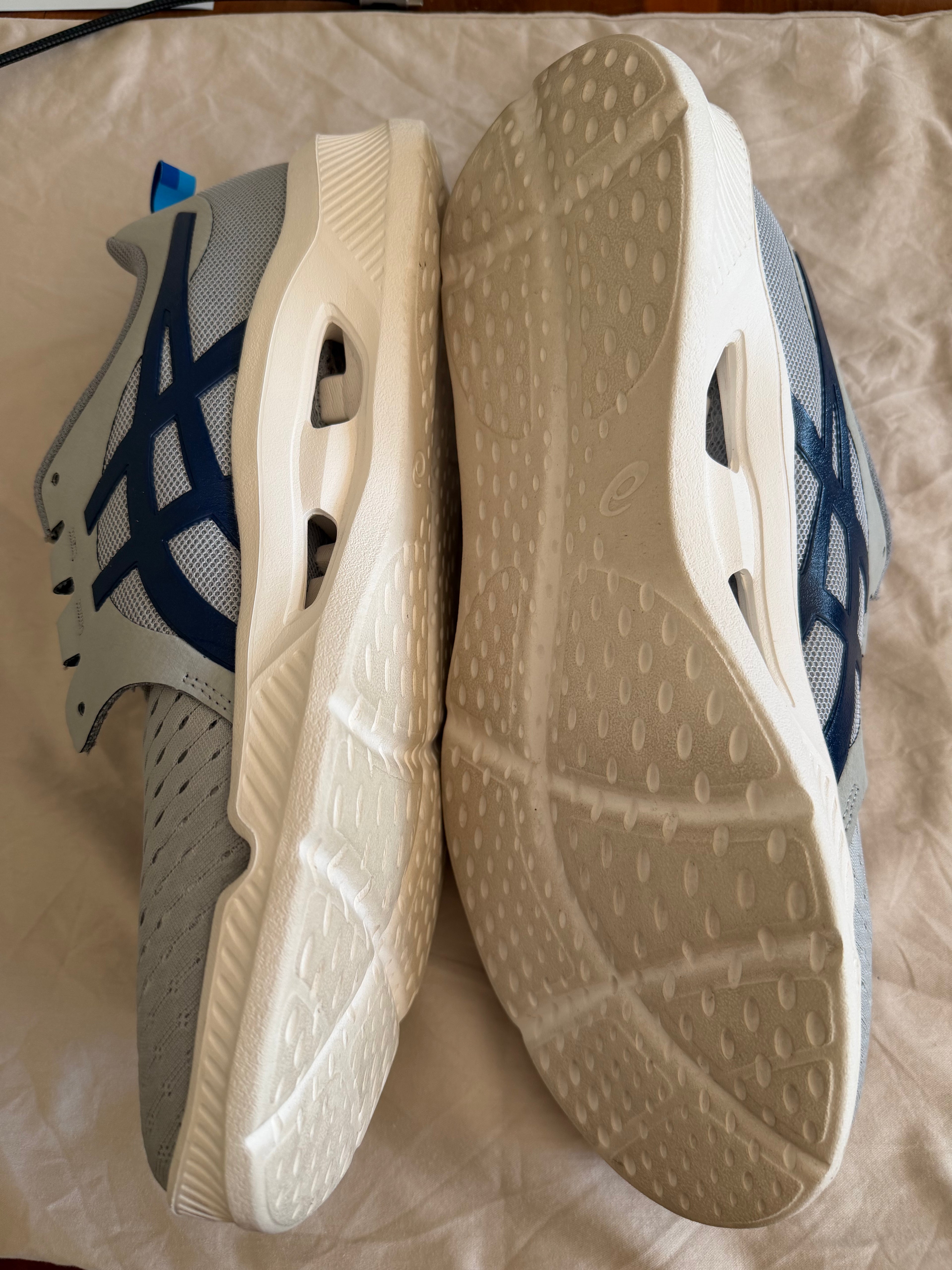 Side and sole view of ASICS Tokyo 2020 trainers showing tread and outsole